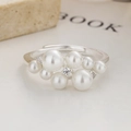 Close-up of 925 sterling silver ring with cluster pearls and sparkling zirconia stones - Adjustable Open / White Gold
