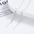 Elegant 925 sterling silver star dangle earrings with long tassels on a ceramic plate - 925 Silver / White Gold