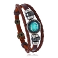 Close-up of Cancer zodiac braided leather bracelet with silver beads and glass charm - Cancer