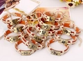 Detail of vintage bronze zodiac charms on hand-woven leather bracelets in various designs - Set of 12 Constellations