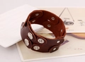 Detail view of dark brown wide leather punk bracelet with double-row metal snap buttons - Brown