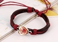 Macro detail of bohemian braided leather bracelet featuring a heart mandala glass charm - Red Line (Heart Mandala)