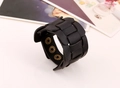 Detail of vintage black braided wide leather bracelet with adjustable bronze snap buttons - Black