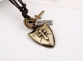 Detail of vintage bronze shield pendant and engraved rectangular tag on leather necklace - Shield