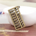 Antique bronze abacus pendant for DIY jewelry making on vintage paper background - Abacus Style / Bronze