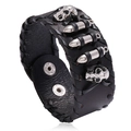 Punk black leather bracelet with silver skull motifs and bullet rivets on white background - Black