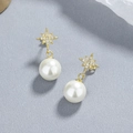 Elegante 925 sterling zilveren ster oorstekers met witte parels en gouden afwerking - 925 zilver / Goud
