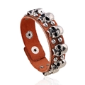 Punk brown leather bracelet with silver skull rivets and studs on white background - Brown Skull Style