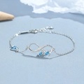 Bracciale tartaruga infinito in argento 925 con cristalli blu e ciondolo a cuore - Argento 925 / Platino (Zirconia Blu)