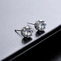 Classic round zircon stud earrings with silver crown setting on a black leather background - Water Ripple Style (X673-A)