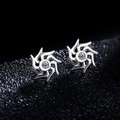 Silver vortex star stud earrings with a sparkling central cubic zirconia on black texture - Silver Sunburst Style (X179-B)