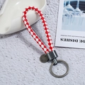 Detail of red and white braided PU leather keychain with matte gunmetal finish ring - Single OPP Bag Packaging / Brushed Silver + Red White