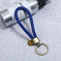 Close-up of blue braided leather keychain with antique bronze metal ring and blank tag - Single OPP Bag Packaging / Blue