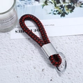 Close-up of red and black braided leather keychain with polished silver metal ring - Silver Tone + Black Red Rope