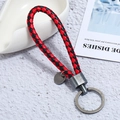 Detail of red and black braided PU leather keychain with brushed grey metal hardware - Single OPP Bag Packaging / Brushed Silver + Black Red