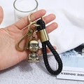 Detail of vintage bronze Buddha charm on black braided leather keychain with lobster clasp - Buddha Style (CY045)