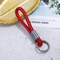 Close-up of red and black woven leather keychain with dark grey metal buckle and ring - Antique Silver + Red Black Rope