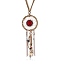 Detail of Bohemian dreamcatcher necklace with red gemstone and layered metallic chains - Beige