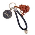 Close-up of leather braided Leo keychain with bronze zodiac pendant and wooden horse charm - Single OPP Bag Packaging / Leo
