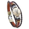 Macro shot of Taurus leather bracelet with hand-woven layers and vintage metal bull pendant - Taurus