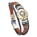 Detail of woven brown leather bracelet with Leo zodiac bronze charm and metal beads - Leo