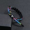 Macro shot of a braided zodiac bracelet with a rainbow gradient and Capricorn symbol - Capricorn