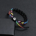 Macro shot of colorful rainbow braided shoelace bracelet with black logo cylinder - Libra