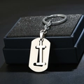 Close-up of letter I engraved on brushed stainless steel keychain in a black gift box - Letter I / Silver