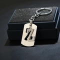Macro shot of silver stainless steel keychain featuring a hollow letter Z pendant on black foam - Letter Z / Silver