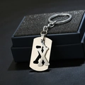 Detailed macro view of silver metal keychain with letter X pendant in a gift box - Letter X / Silver