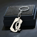 Detail of a polished stainless steel letter Q keychain pendant on a premium black display box - Letter Q / Silver