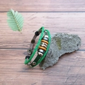 Multilayer beaded leather bracelet featuring green woven cords and natural wood beads - Green