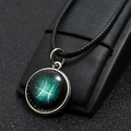 Macro shot of a Pisces zodiac pendant featuring a blue galaxy background on a display stand - Pisces