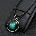 Detailed close-up of Scorpio zodiac pendant with glowing constellation on black cord - Scorpio