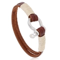 Handmade leather bracelet featuring a silver horseshoe buckle and woven rope accents - Brown