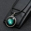 Macro shot of Sagittarius constellation necklace with silver border and black woven rope - Sagittarius