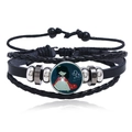 Close-up of multilayer leather bracelet featuring a Leo zodiac luminous glass cabochon - Leo