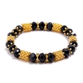 Elastic beaded bracelet with multifaceted black crystal beads and golden textured metal spacers - Black