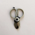 Retro bronze scissor pendant in woven leather keychain style with vintage finish - Scissors