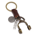 Handmade leather keychain with bronze headphone charm and engraved pendant on white background - Dark Brown