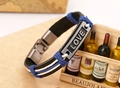 Dettaglio di un bracciale multistrato in pelle intrecciata con placca metallica LOVE vintage - Stile Uomo
