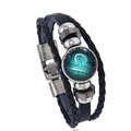 Macro detail of Libra zodiac glass charm on multilayer braided black leather bracelet - Libra