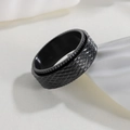 Detailed macro view of 8mm black rotating stress relief ring with cross-hatch texture - Black Mesh Spinner