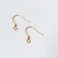 Detailed macro shot of golden S925 sterling silver earring hooks for DIY jewelry making - Rose Gold