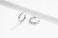 Detailed macro view of S925 sterling silver hoop earrings with polished mirror finish - 925 Silver / White
