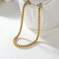 Elegant 2mm golden stainless steel box chain necklace displayed on white ceramic base - Gold 50cm*3mm