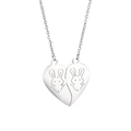 Detail of interlocking heart pendants with engraved cartoon rabbits on steel necklaces - Little Rabbit