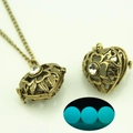 Detail of vintage heart locket necklace with internal glowing blue stone and bronze finish - Heart Antique Bronze Blue Light (YJ10-6073)