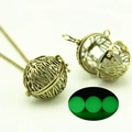 Detailed view of hollow vintage bronze locket necklace showing green glow in the dark - Antique Bronze Green Light (YJ10-6074)