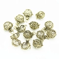 Close-up of vintage bronze hollow filigree locket pendants with detailed openwork patterns - Gold Hollow Ball Pendant (YJ6-1059)
